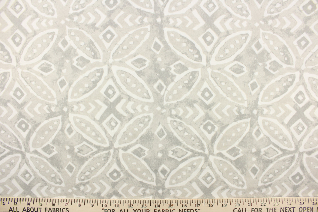 This outdoor fabric features a medallion design in white against a pale gray .