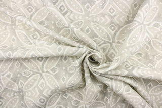 This outdoor fabric features a medallion design in white against a pale gray .