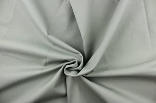 Twill fabric in a solid gray with greenish undertones .