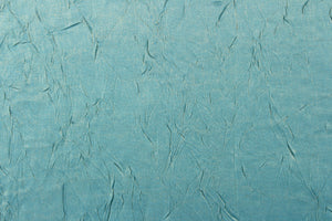 Taffeta fabric features a crinkle in iridescent blue and gold.
