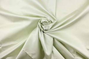 Taffeta fabric in solid pale green. 