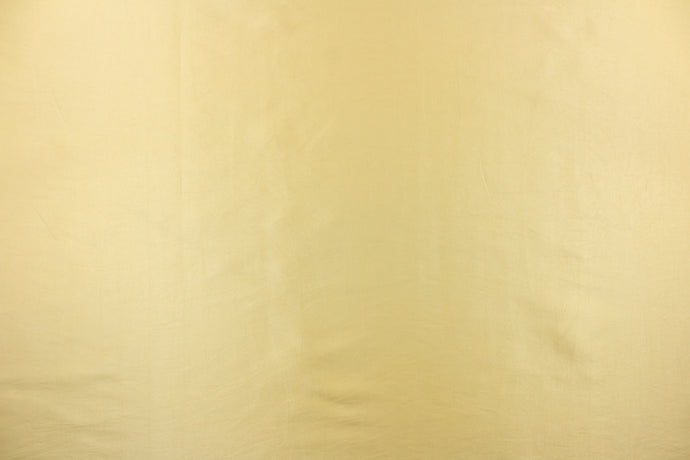  Taffeta fabric in a solid light gold. 