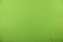 Load image into Gallery viewer, Poplin fabric in a solid lime green. 
