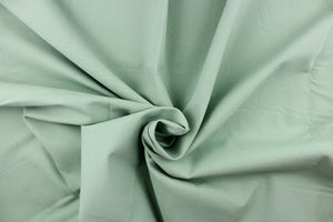 Poplin fabric in a solid light green.