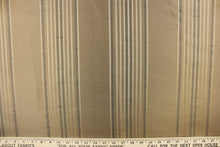 Load image into Gallery viewer, This fabric features a vertical striped design in gold and pale black on a beige background
