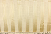 Load image into Gallery viewer, This stunning yarn dyed fabric features a  wide vertical striped pattern in cream and light gold.
