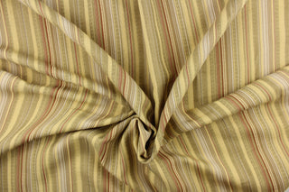 This rich woven yarn dyed fabric features a vertical bold multi width striped pattern in brown, gray, beige, and cream. 