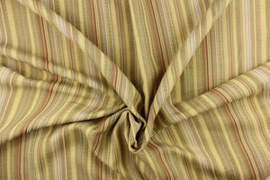 This rich woven yarn dyed fabric features a vertical bold multi width striped pattern in brown, gray, beige, and cream. 
