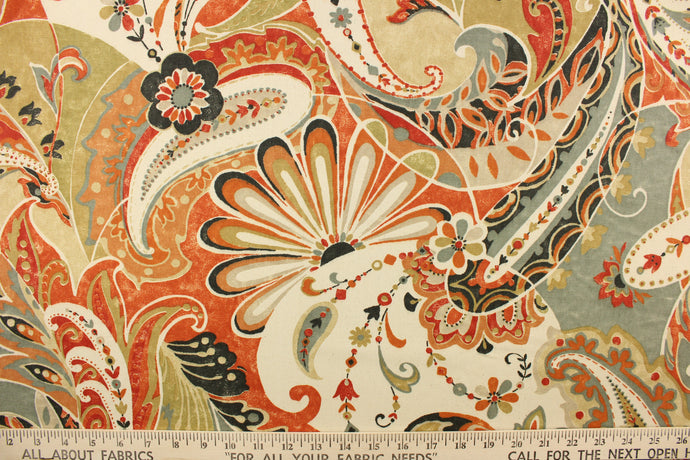 This fabric features a whimsical floral design in orange, red, gray, beige, khaki, cream and dark gray.