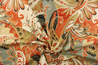 This fabric features a whimsical floral design in orange, red, gray, beige, khaki, cream and dark gray.