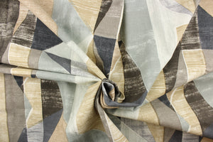 This fabric features and geometric  design of angles in gray, khaki, white and pale blue .