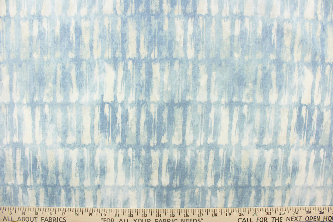 This fabric features an abstract design in shades of light blues and white. 