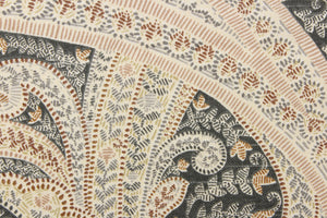 This fabric features a paisley design in gray, brown, rose pink, off white, and khaki.