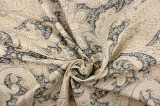 This fabric features a paisley design in gray, brown, rose pink, off white, and khaki.