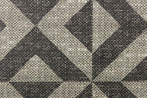 This vinyl fabric features a x design in varies shades of gray. 