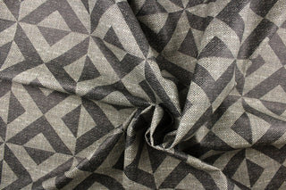 This vinyl fabric features a x design in varies shades of gray. 