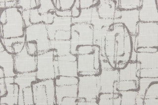 This contemporary abstract design features interlocking geometrical shapes in clay set against a off white background.
