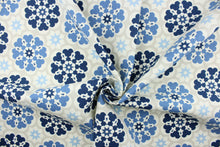 Load image into Gallery viewer,  This screen printed fabric features large and small flowers in shades of blue and off white on a khaki background.

