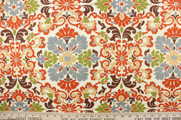 This intricate damask print features large and small flowers in shades of orange, olive green, brown and gray on a cream background. 