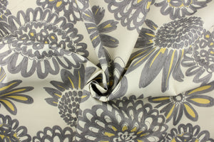 This fabric features a large print floral design in gray and yellow on a beige background and is perfect for any project where the fabric will be exposed to the weather.  
