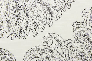 This fabric features a large medallion in black on a white background. 