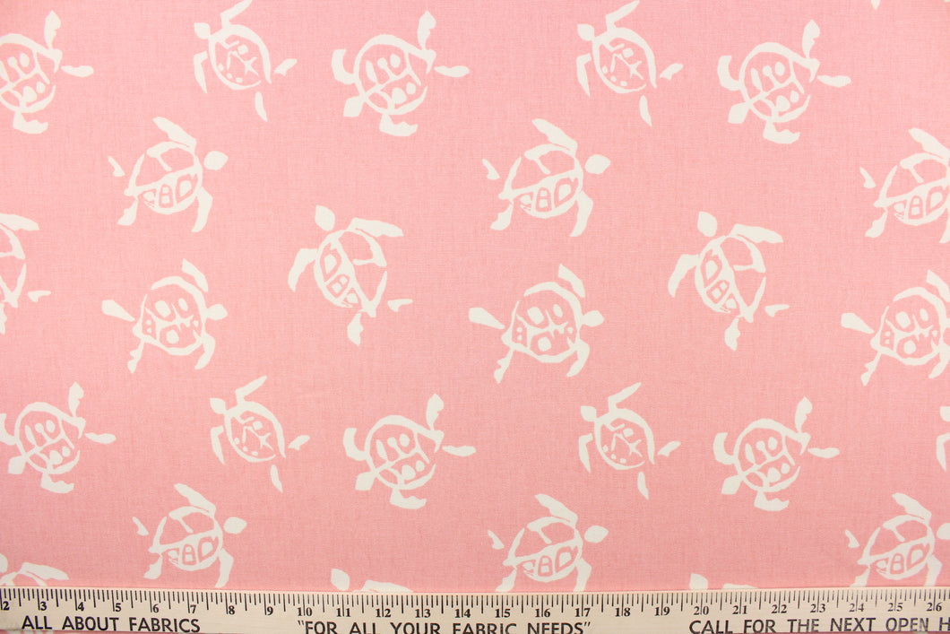 This fun fabric features cream colored turtles on a pink background.