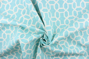 This fabric features a geometrical print in aqua and beige with white accents.  
