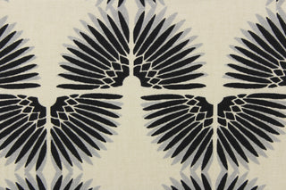 This contemporary screen printed fabric features a caterpillar in gray and black set against a beige background. 