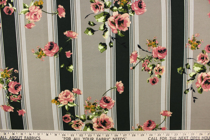  This georgette fabric features a stripe and floral design in taupe, white, green, pink, green, and golden yellow. 