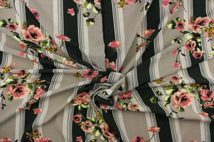  This georgette fabric features a stripe and floral design in taupe, white, green, pink, green, and golden yellow. 