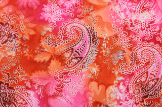 This 1 way lycra fabric features a paisley design in orange, pink, red, and white.