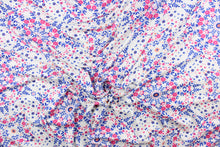 Load image into Gallery viewer, This lycra jersey blend fabric features a floral design in blue, pink, white, and orange.
