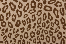 Load image into Gallery viewer, This jersey fabric features a leopard design in brown against a taupe. This is a interlock knit acetate jersey.
