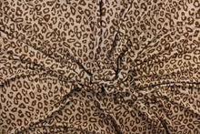 Load image into Gallery viewer, This jersey fabric features a leopard design in brown against a taupe. This is a interlock knit acetate jersey.
