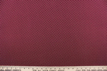 Load image into Gallery viewer, This interlock jersey fabric features a dot design in white against a burgundy background
