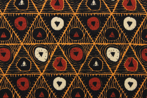 This jersey fabric features a tribal geometric design in orange, cream, black, and dark orange