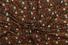 Load image into Gallery viewer, This jersey fabric features a tribal geometric design in orange, cream, black, and dark orange
