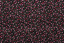 Load image into Gallery viewer, This jersey fabric features a dainty floral design in pink, green, and dark pink against black background.
