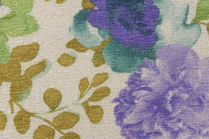 This knit fabric features a floral design in a sparkly  gold. turquoise, purple, and green. 