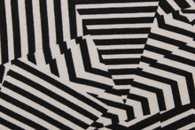 Load image into Gallery viewer, This 4 way stretch lycra fabric features an abstract design in black, and pale beige. 
