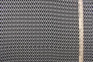 This 8 way stretch lycra fabric features a chevron design in black and white.