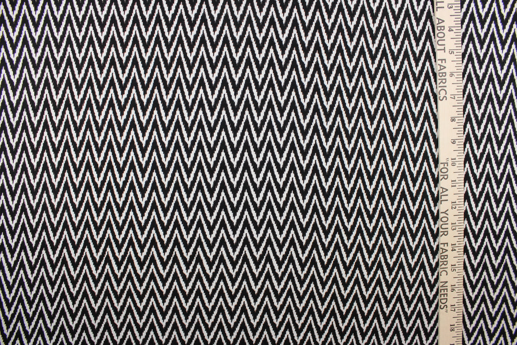 This 8 way stretch lycra fabric features a chevron design in black and white.