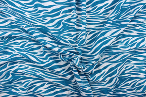  This jersey blend fabric features a zebra stripe design in teal and white.