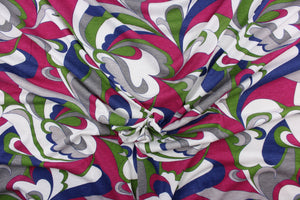  This jersey fabric features an abstract design in fuchsia, gray, green, blue and white.