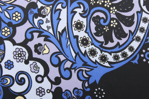 This chiffon fabric features a floral design in blue, pale yellow, black, and silver.