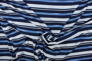  This georgette fabric features a  stripe design in varying shades of blue and white. 