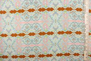 This chiffon fabric features a demask design in pale blue, seafoam green, pink, white, and yellow against a brown orange. 