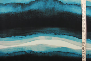 This chiffon fabric features a Ombre design in teal green, deep teal, turquoise, black, white, and gray. 