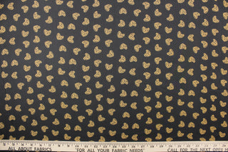  This chiffon fabric features a heart design with a leopard design in tan and black against a black  background.