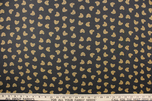  This chiffon fabric features a heart design with a leopard design in tan and black against a black  background.